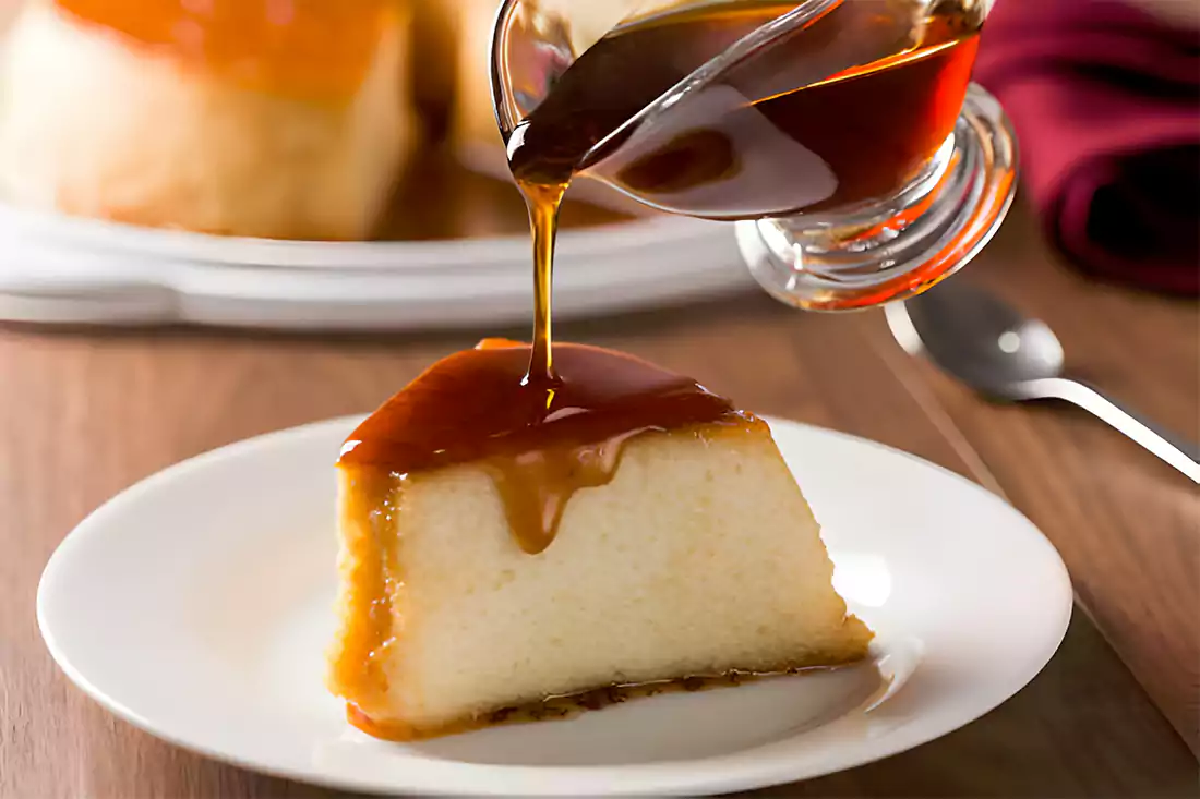 Pouring smooth caramel sauce over chocolate cake, enhancing its sweetness and texture