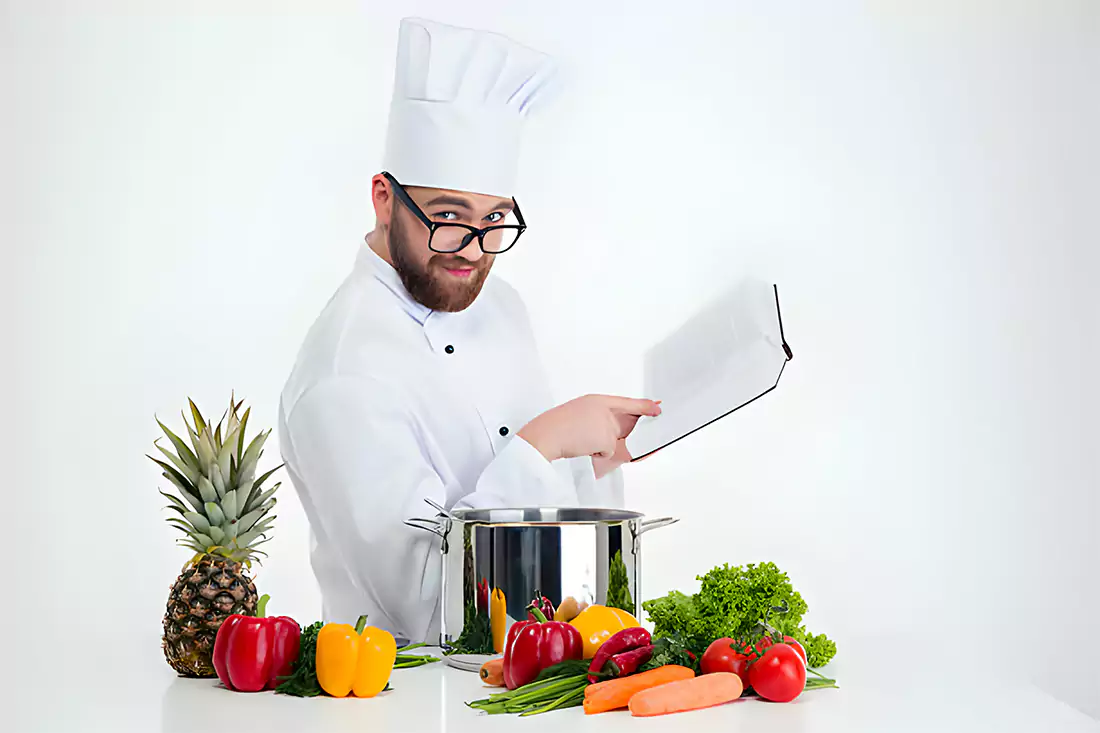 A chef demonstrating cooking techniques in a kitchen, relevant to tips and tricks for making Porcupine Meatballs