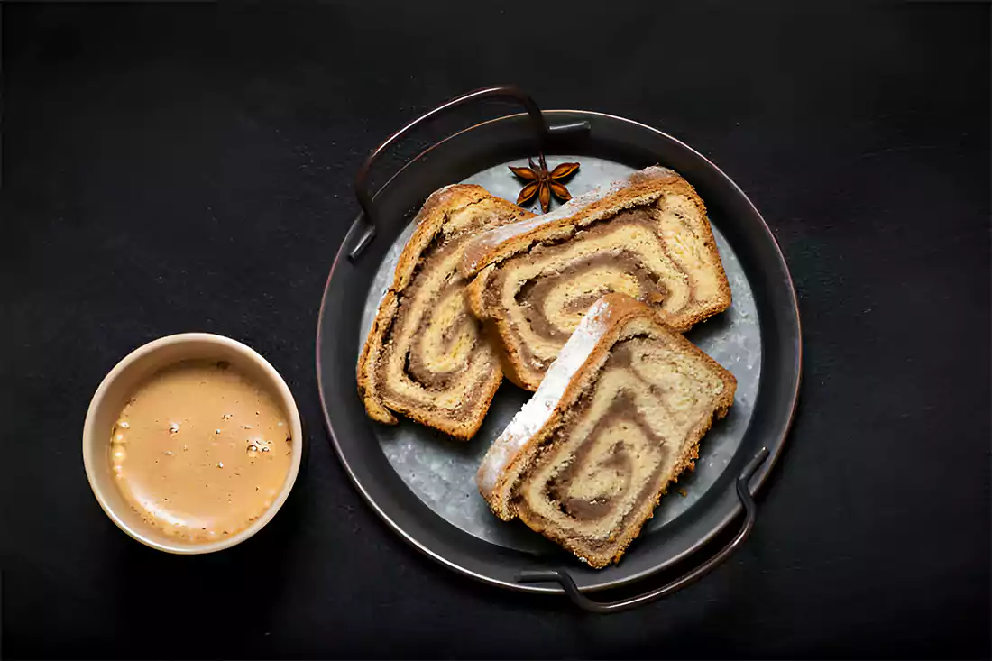 Sliced cinnamon bread served with a cup of coffee for breakfast