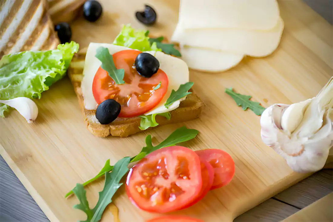 Variety of ingredients like ground beef, cheese, and vegetables for Chopped Cheese Sandwich