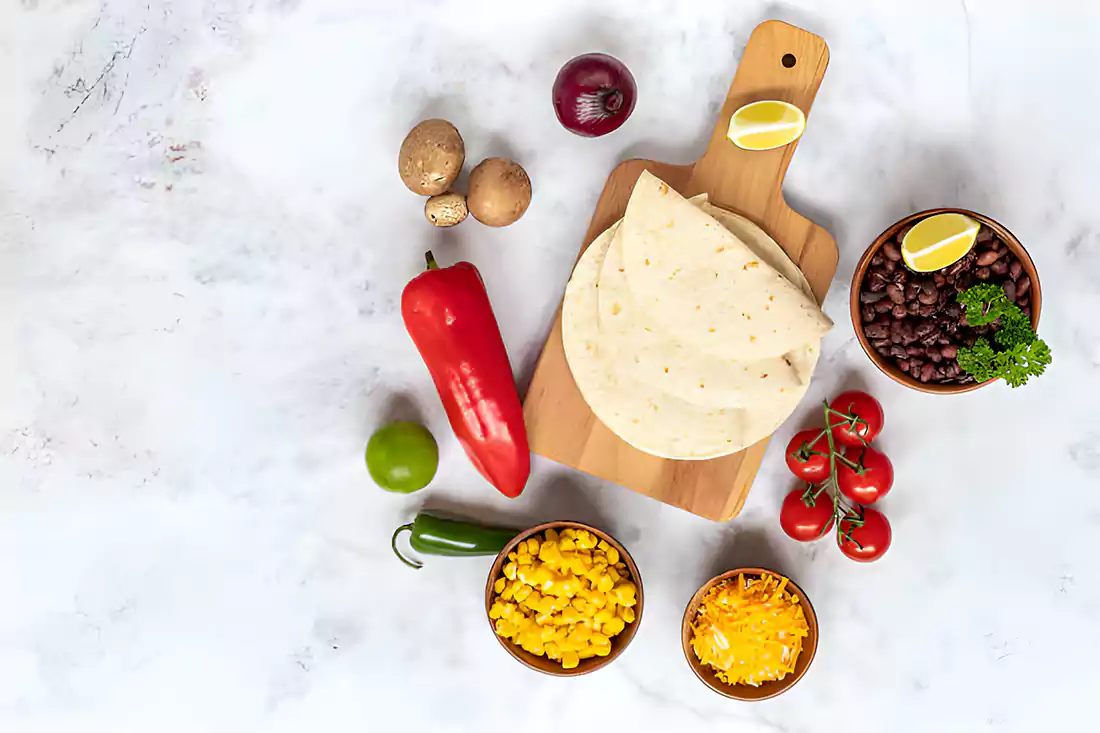 Ingredients for crescent roll taco bake including crescent rolls, ground beef, cheese, and taco seasoning.