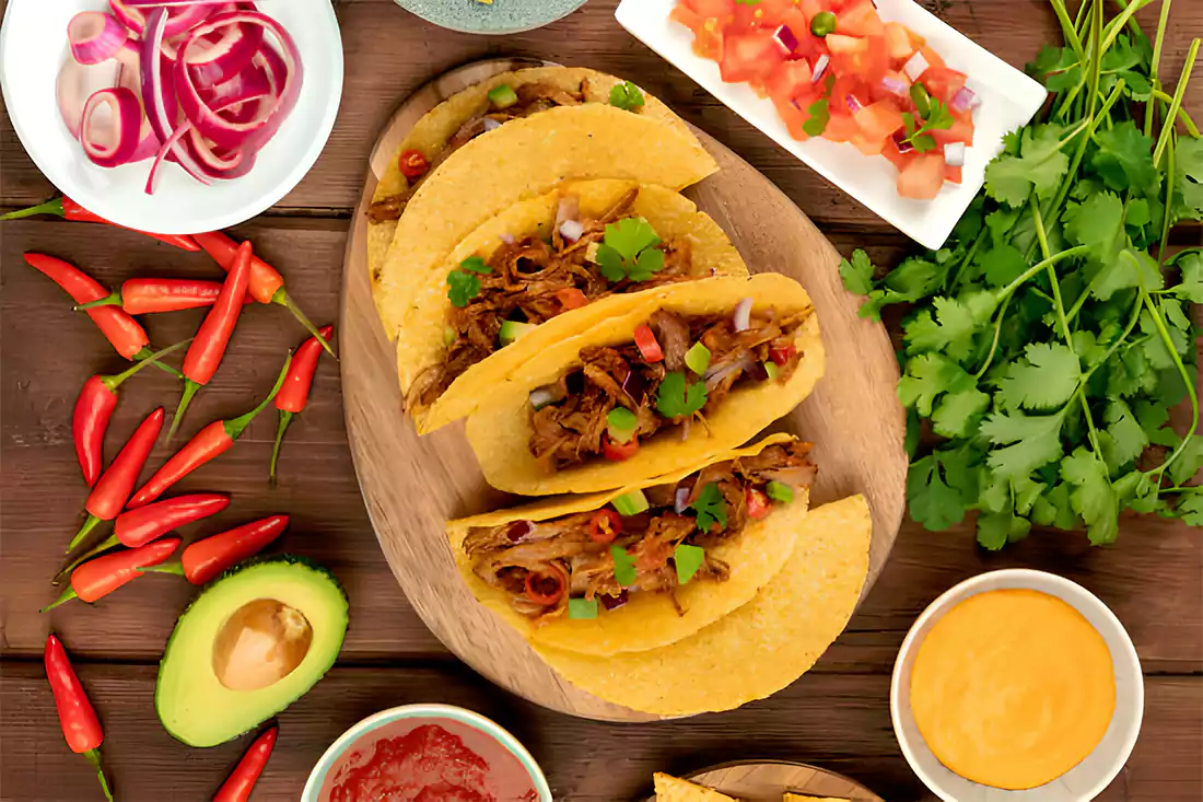 Assorted fresh ingredients for baked tacos arranged in a flat lay