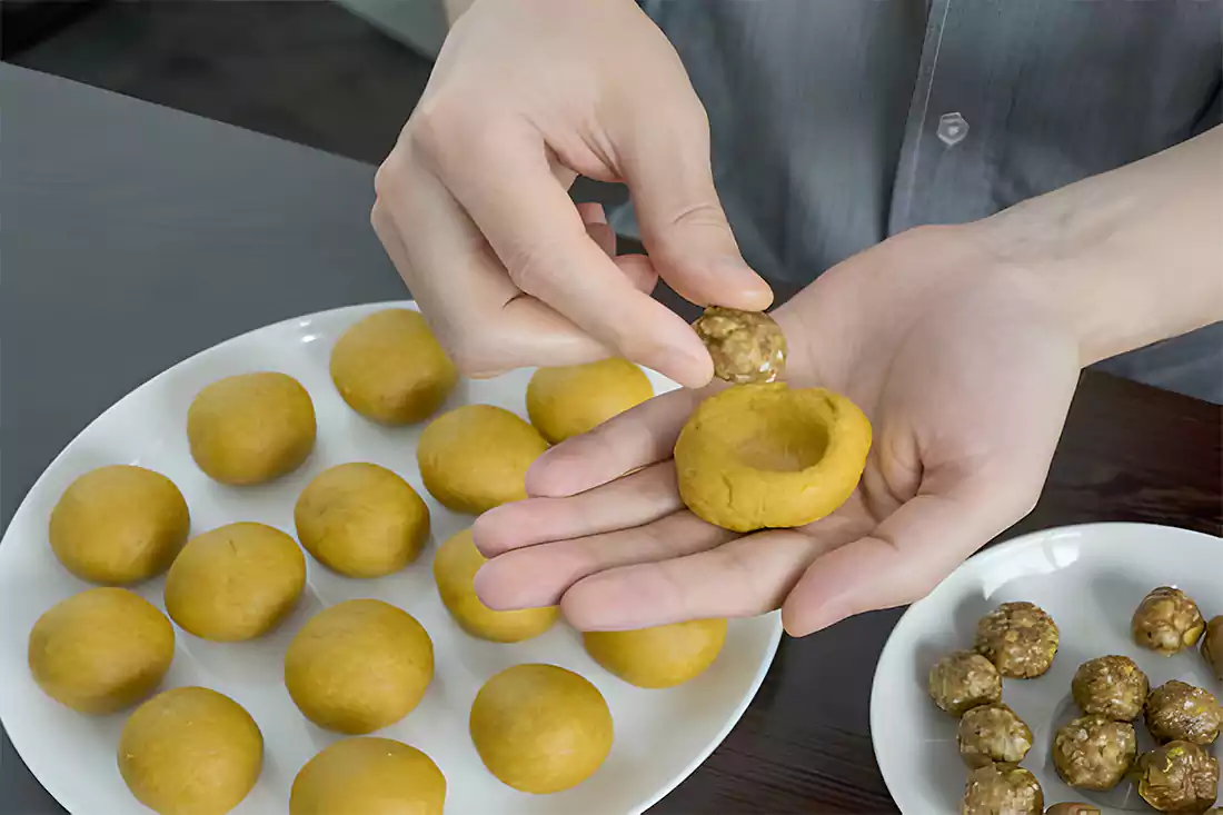 Close-up of a hand holding a serving of Skippy Peanut Butter Balls