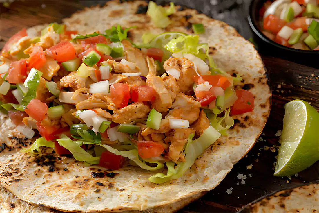 Top view of fresh ingredients laid out for preparing baked chicken tacos