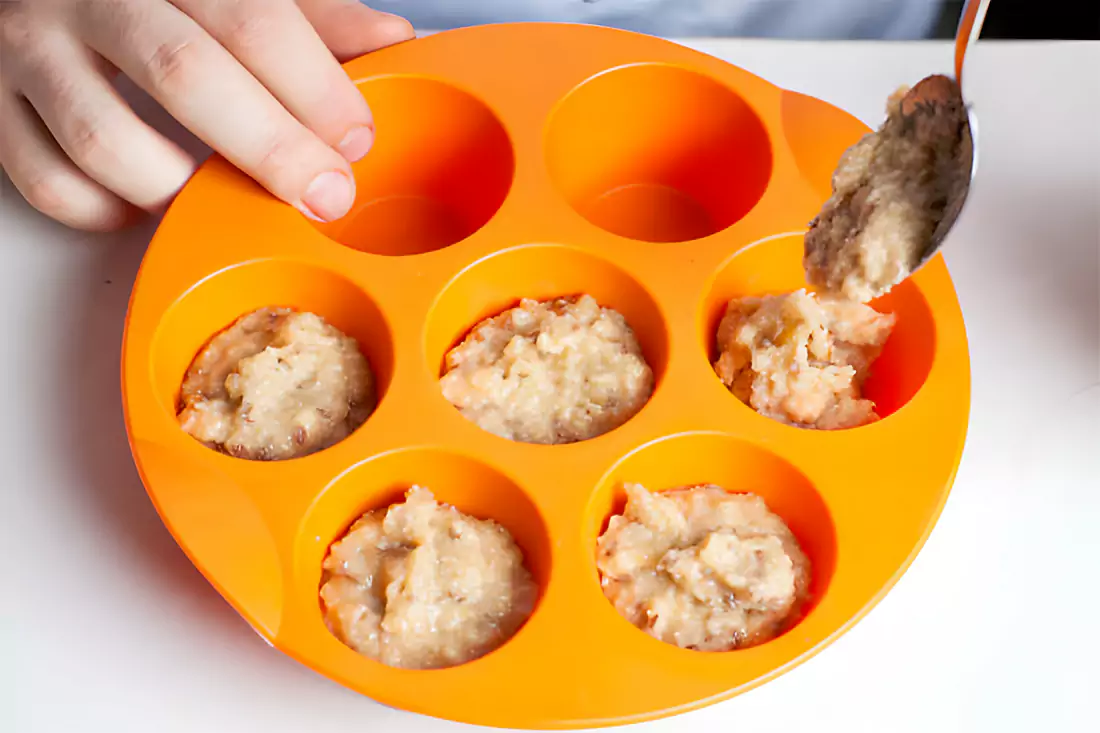 A bowl with creamy peanut butter and powdered sugar being mixed together for preparing peanut butter balls.