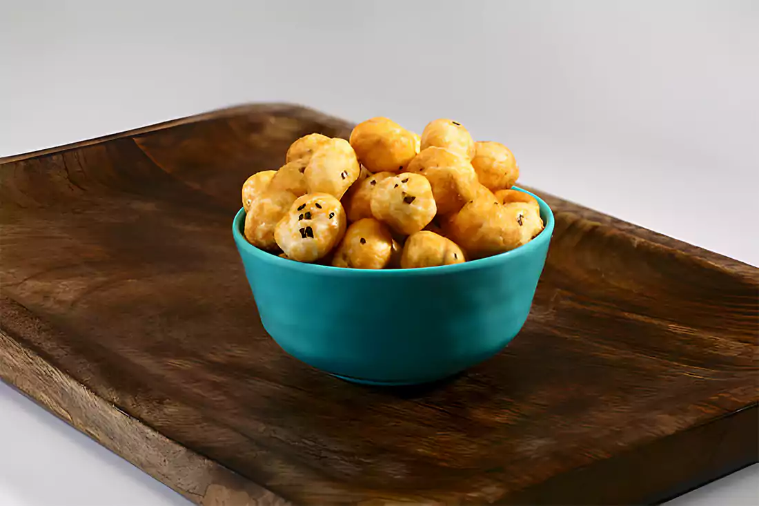 A bowl of Skippy Peanut Butter Balls on a wooden table