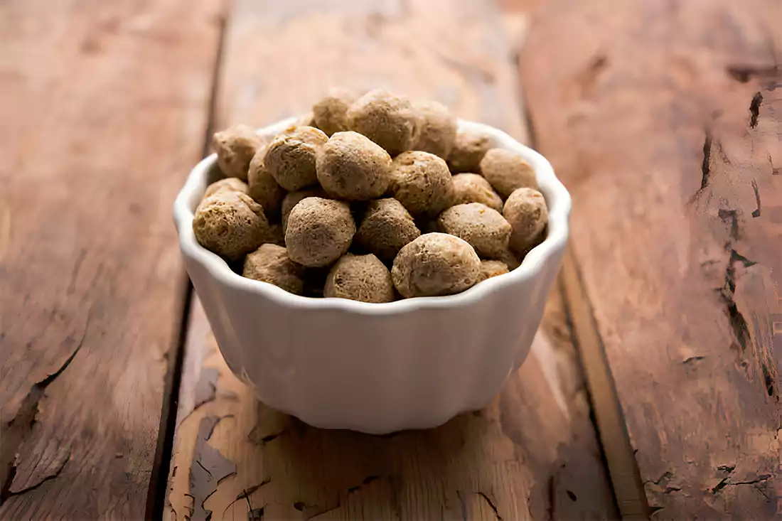 Jar of Skippy Peanut Butter next to homemade peanut butter balls