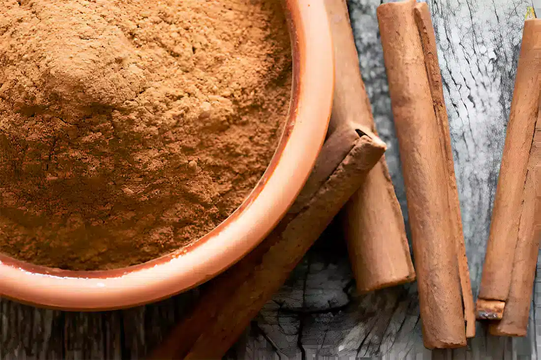 Cinnamon sticks and ground cinnamon, showcasing the spice's inviting aroma and flavor profile