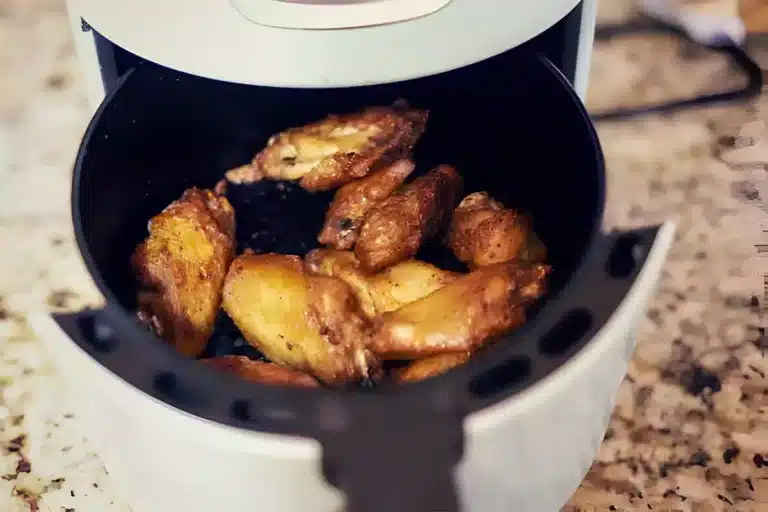 Golden crispy chicken wings fresh out of the air fryer