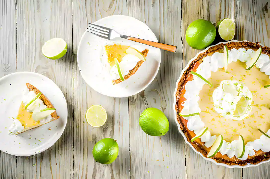 Flat lay of Key Lime Pie ingredients including key lime juice, condensed milk, and graham crackers