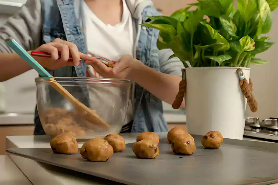 Hands Preparing Peanut Butter Balls in Kitchen