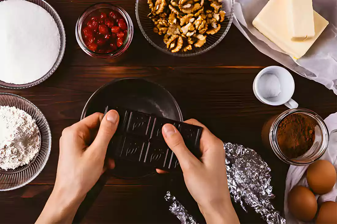 Mixing ingredients for the creamy nougat layer in no bake Snickers bars.